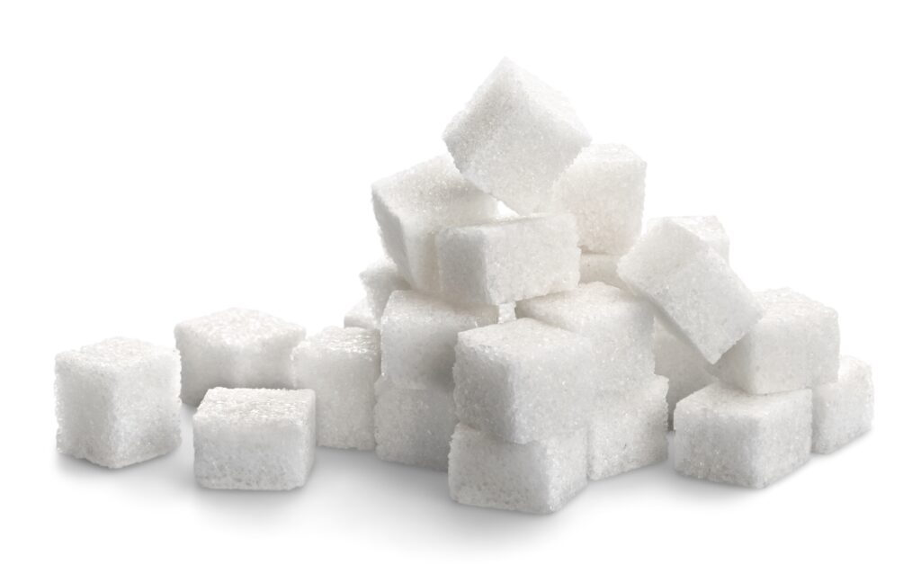 stack of sugar cubes on white background